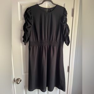Black dress with ruched sleeves and smocked waist